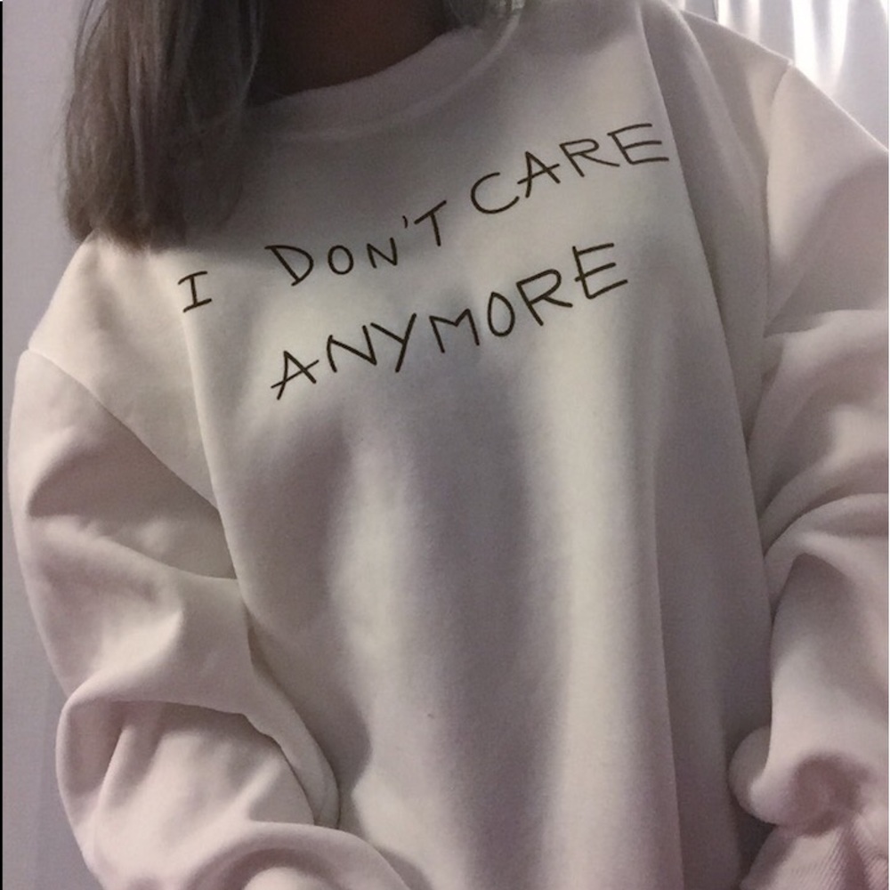 White “I don’t care” sweater gun sleeve